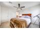 Bedroom featuring a ceiling fan, dresser, telescope, and door that leads to the bathroom at 2726 S 160Th Ave, Goodyear, AZ 85338