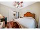 An inviting bedroom with a ceiling fan, a decorated headboard, and hardwood floors at 2726 S 160Th Ave, Goodyear, AZ 85338