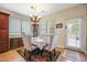An elegant dining room featuring a chandelier, a decorative cabinet, and an exterior door at 2726 S 160Th Ave, Goodyear, AZ 85338