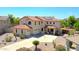 Stunning two-story home with a tile roof, well-manicured landscaping, a long driveway, and desert plants at 2726 S 160Th Ave, Goodyear, AZ 85338