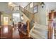 Grand foyer featuring a staircase, hardwood floors, and wrought iron railing at 2726 S 160Th Ave, Goodyear, AZ 85338