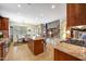 Open kitchen and dining area showcasing a spacious island, tile floors, and modern appliances at 2726 S 160Th Ave, Goodyear, AZ 85338