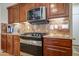 A kitchen showcasing stainless steel appliances, granite countertops, and beautiful custom cabinetry at 2726 S 160Th Ave, Goodyear, AZ 85338