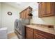 Functional laundry room with front load washer and dryer, granite countertop, and storage cabinets at 2726 S 160Th Ave, Goodyear, AZ 85338