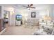 Comfortable living room features a fan, carpet and a large tv for entertainment at 2726 S 160Th Ave, Goodyear, AZ 85338