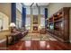 Elegant living room featuring soaring ceilings, a fireplace, and custom built-in shelving at 2726 S 160Th Ave, Goodyear, AZ 85338