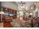 Open living area with hardwood flooring, custom built-in shelves and a staircase at 2726 S 160Th Ave, Goodyear, AZ 85338
