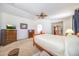 Spacious main bedroom with two dressers, neutral carpet, fan and light, and vaulted ceiling at 2726 S 160Th Ave, Goodyear, AZ 85338
