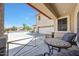 Cozy front porch with comfortable seating overlooking the manicured front yard and a three car garage at 2726 S 160Th Ave, Goodyear, AZ 85338