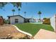 Expansive backyard with green grass, pool, trees, white brick exterior, and patio at 2820 E Surrey Ave, Phoenix, AZ 85032