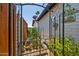 Enclosed garden with a metal gate, greenery, and gravel ground cover at 2820 E Surrey Ave, Phoenix, AZ 85032