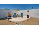 Cozy backyard sitting area featuring blue Adirondack chairs, gravel, and decorative plants at 2820 E Surrey Ave, Phoenix, AZ 85032