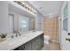 Bathroom features double sinks with new fixtures and updated mirror and vanity at 2820 E Surrey Ave, Phoenix, AZ 85032