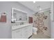 Clean bathroom featuring updated vanity, decorative shower curtain, and light wood-colored floors at 2820 E Surrey Ave, Phoenix, AZ 85032