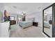 Bright bedroom features light wood floors, light blue bedding, ceiling fan, and furnishings at 2820 E Surrey Ave, Phoenix, AZ 85032