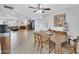 Spacious open-concept dining room with tile floors connecting to a living room at 2820 E Surrey Ave, Phoenix, AZ 85032