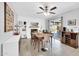 Bright dining area with sliding glass doors, white brick fireplace, modern light fixture, and a coffee bar at 2820 E Surrey Ave, Phoenix, AZ 85032