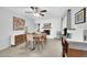 Bright dining area with a modern chandelier, a white brick fireplace, and a mini fridge at 2820 E Surrey Ave, Phoenix, AZ 85032