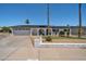 Charming one-story home featuring a well-maintained front yard, a two car garage, and solar panels at 2820 E Surrey Ave, Phoenix, AZ 85032