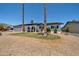 Charming single-story home with desert landscaping, solar panels, and a white brick facade at 2820 E Surrey Ave, Phoenix, AZ 85032
