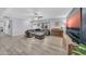 Inviting living room with a gray sectional sofa, ottoman, and a large TV at 2820 E Surrey Ave, Phoenix, AZ 85032