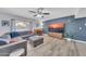 Comfortable living room with a gray sectional sofa, stylish decor, and a large TV at 2820 E Surrey Ave, Phoenix, AZ 85032