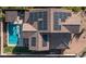 Aerial view featuring a swimming pool and solar panels installed on the roof of this beautiful home at 2915 W Night Owl Ln, Phoenix, AZ 85085