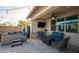 Relaxing backyard patio with a spa, TV, comfortable seating and an outdoor living space at 2915 W Night Owl Ln, Phoenix, AZ 85085