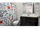 This bathroom features a toilet, vanity, and a shower curtain with a science-themed pattern at 2915 W Night Owl Ln, Phoenix, AZ 85085