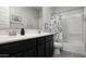 Charming bathroom featuring dual sinks and a shower and tub with a playful shower curtain at 2915 W Night Owl Ln, Phoenix, AZ 85085