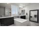 This bathroom has two sinks, a tub, mirrors, and a window at 2915 W Night Owl Ln, Phoenix, AZ 85085