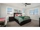 This bedroom features a bed with two end tables with lamps, a mirror, and two windows at 2915 W Night Owl Ln, Phoenix, AZ 85085