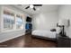 This bedroom has a striped bedspread, a window with shutters, and a ceiling fan at 2915 W Night Owl Ln, Phoenix, AZ 85085