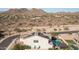 A home with solar panels and desert landscaping, along with a pool and outdoor lounge area at 2915 W Night Owl Ln, Phoenix, AZ 85085