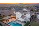 A white two-story home with solar panels, desert landscaping, and a backyard pool with spa and seating at 2915 W Night Owl Ln, Phoenix, AZ 85085