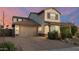 Charming two-story home with a well-manicured front yard, a spacious driveway, and a two-car garage at 2915 W Night Owl Ln, Phoenix, AZ 85085