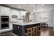 Open kitchen showcasing a center island with seating, stainless steel appliances, and stylish lighting fixtures at 2915 W Night Owl Ln, Phoenix, AZ 85085