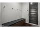 Convenient mud room features built-in bench with storage and coat hooks by the door at 2915 W Night Owl Ln, Phoenix, AZ 85085