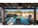 Inviting pool area with water feature, pergola, and desert views, perfect for relaxation at 2915 W Night Owl Ln, Phoenix, AZ 85085