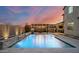 Beautiful backyard pool featuring a waterfall feature, basketball hoop, hot tub, and ambient lighting at 2915 W Night Owl Ln, Phoenix, AZ 85085