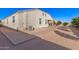 Neutral colored exterior with backyard featuring desert landscaping, patio, and trees at 30089 W Rockmount Ave, Buckeye, AZ 85396
