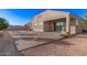 Backyard with desert landscaping, patio, and neutral colored exterior at 30089 W Rockmount Ave, Buckeye, AZ 85396
