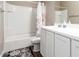 Bright bathroom features a white vanity, sink, and tiled tub-shower combo at 30089 W Rockmount Ave, Buckeye, AZ 85396