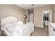 Bedroom with white furnishings, plush carpeting, closet, and neutral-colored walls at 30089 W Rockmount Ave, Buckeye, AZ 85396