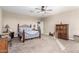 Cozy bedroom with plush carpeting, ceiling fan, and views of the home's interior at 30089 W Rockmount Ave, Buckeye, AZ 85396