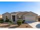 Beautiful single-story home featuring a two-car garage and well-manicured desert landscaping at 30089 W Rockmount Ave, Buckeye, AZ 85396