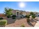 Beautiful single-story home with desert landscaping, mature trees, and a convenient two-car garage at 30089 W Rockmount Ave, Buckeye, AZ 85396