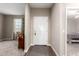 Bright, inviting foyer leading to a living space and bedroom; neutral color palette at 30089 W Rockmount Ave, Buckeye, AZ 85396