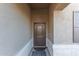 Inviting front entryway featuring a stylish door, neutral stucco walls, and a covered porch at 30089 W Rockmount Ave, Buckeye, AZ 85396