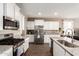 Well-lit kitchen featuring granite countertops, stainless steel appliances, and white cabinetry at 30089 W Rockmount Ave, Buckeye, AZ 85396
